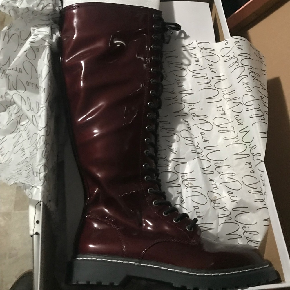 Knee high patent leather boots.